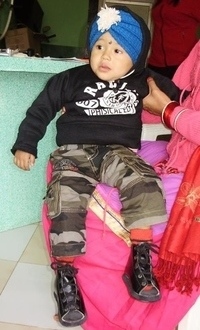 Little Nepalese boy with his special shoes for clubfoot